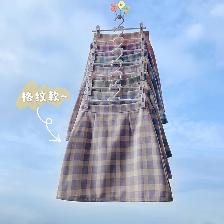 粉白格a字包臀裙